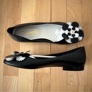 Brand new Chanel flats. Comes with box. Black and white leather. Floral detail